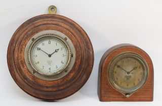 An early 20th century Smiths of London oak cased dome topped car dashboard clock, the dial with