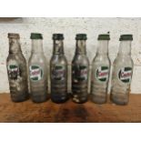 A set of six Castrol glass one pint bottles, all with caps