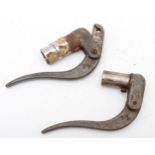 A pair of vintage brake leavers with W motif.