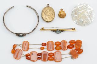 A group of jewellery to include an amber bracelet, a gold plated bar brooch with blue paste stone