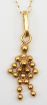 A gold abstract person pendant on chain, 24mm, stamped 325, 1.1gm.