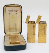 Dunhill, three textured gold plated gas lighters.