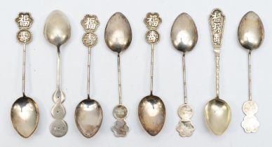 A Chinese set of six tea spoons, stamped silver, Hong Kong, and two other examples, 60gm.