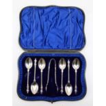 An Edward VII silver Apostle spoons and sugar tongs, Sheffield 1907, 96gm, cased.