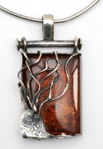 A silver Baltic amber modernist pendant, 55 x 27cm, on chain, 39gm.