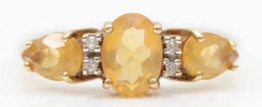 A 9ct gold citrine three stone dress ring, P-Q, 1.9gm.