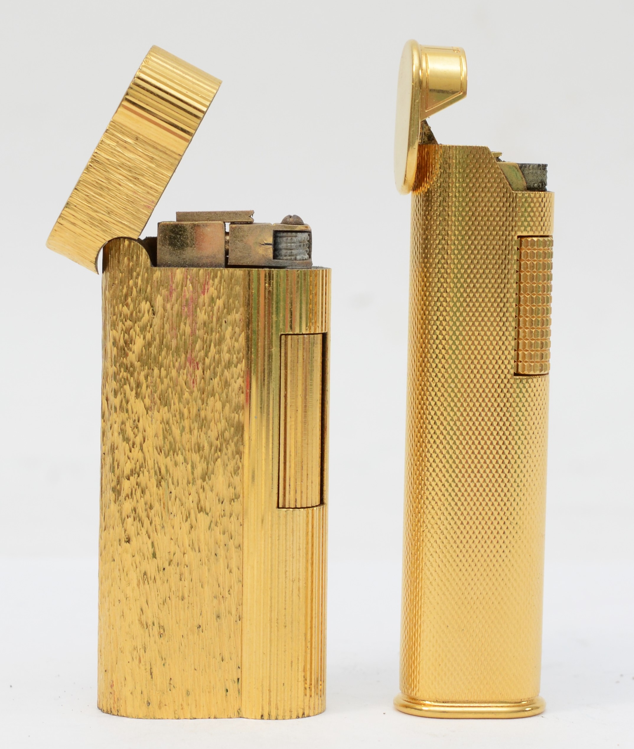 Dunhill, Two textured gold plated gas lighters, No E30436, No 019.