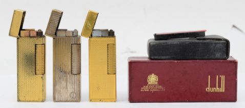 Dunhill, Two gold plated gas lighters and a siller plated example.