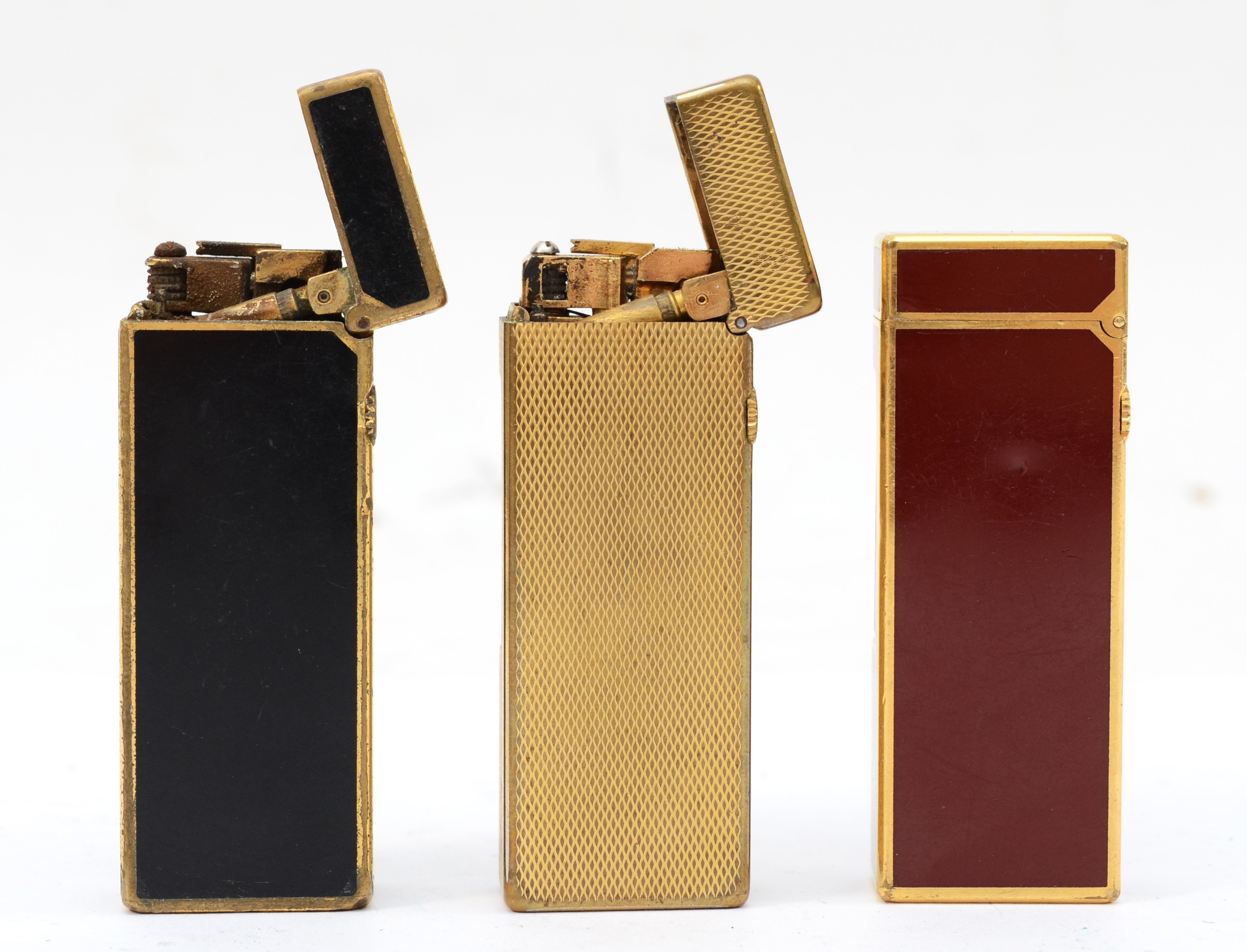 Dunhill, Three gold plated gas lighters, black No 17418, gold 24153. - Image 2 of 3