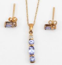 A 9ct gold tanzanite three stone pendant, 15mm, on chain, with matching ear studs, 1.6gm.