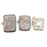 A George V silver vesta case, 4 x 3cm, with foliate scroll decoration, together with two other