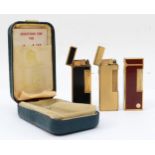 Dunhill, Three gold plated gas lighters, black No 17418, gold 24153.