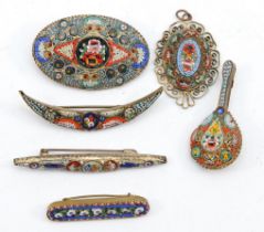 A group of base metal micro mosaic brooches and a pendant.