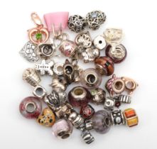 A group of approximately 40 silver charms to include Lovelinks example, 99gm.