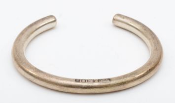 A silver torque bangle, 57mm, London 1996, stephen Cooper, 49gm.