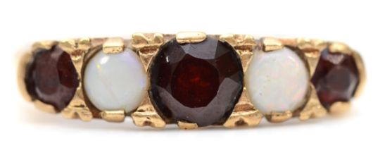 A 9ct gold garnet and opal five stone ring, L-M, 2.1gm.