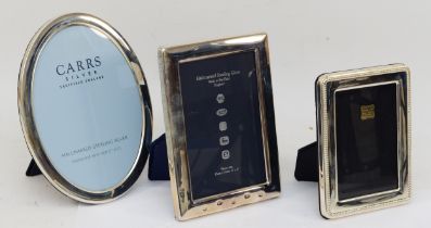 Three modern silver fronted photograph frames with an oval example, 20.5 x 15.5cm, Sheffield 2004.