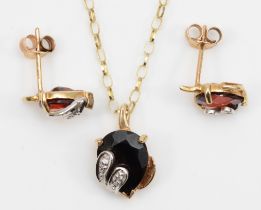 A 9ct gold garnet and diamond pendant, 13mm, on chain, together with a matching pair of ear studs,