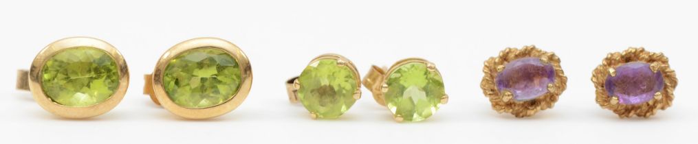 Two pairs of 9ct gold peridot ear studs, 2.9gm, with a pair of amethyst unmarked studs.
