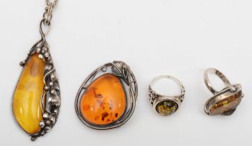 Two silver Baltic amber rings, R, a pendant on chain and brooch, 57gm.