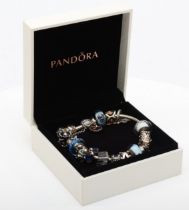 Pandora, a silver charm bracelet and charms to include an owl example, 84gm.