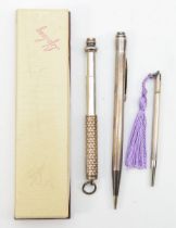 A sterling silver cased 'life long' propelling pencil, 13cm, together with two others.