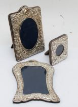 Three silver fronted photograph frames with embossed decoration, largest 19 x 14cm, Sheffield