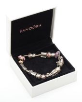 Pandora, a silver charm bracelet and charms to include a wedding cake charm, 78gm.