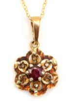 A 9ct gold garnet floral pendant, 18mm, on chain, 1.7gm.