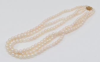 A 14ct gold clasped three strand graduating cultured pearl necklace, 4 - 7mm pearls.