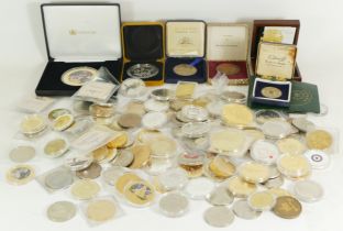 A collection of cased and loose commemorative coinage and other medallions.