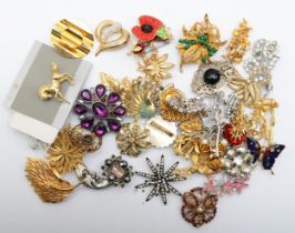 A collection of modern and vintage brooches to include floral examples.