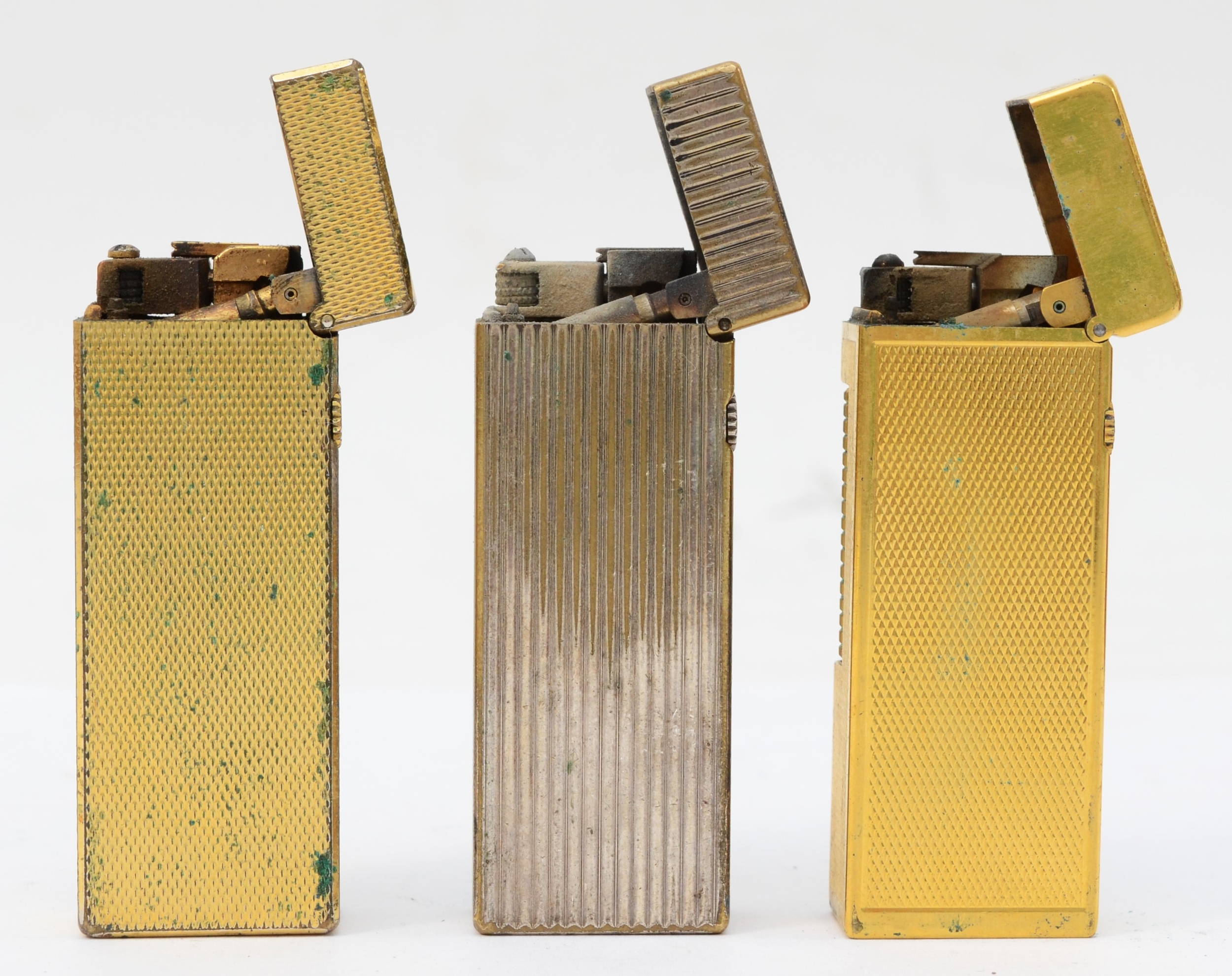Dunhill, Two gold plated gas lighters and a siller plated example. - Image 2 of 2