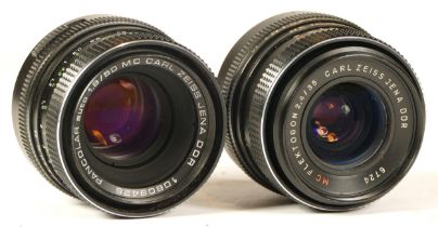 Two camera lenses comprising of a Carl Zeiss Jena Flektogon 35mm lens (working with dust specks