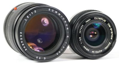 Two camera lenses comprising of a boxed Olympus OM 28mm lens (working) together with a cased Leica