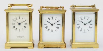 Three 20th century brass and four glass corniche cased carriage clocks to include a Wellington