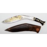 An Indian kukri, the 32cm blade pick dot decorated, with leather scabbard. This bladed product is