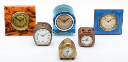 Six assorted clocks to include a 1930s enamel and brass cased clock, the silvered dial with black