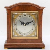 A 20th century walnut cased Elliott dome topped mantle clock, with cantered corners, the brushed