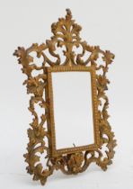 A gilt cast metal ezel mirror, in Rococo style with florid floral and leaf motifs. (lacking glass)