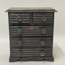 A late 19th century miniature chest of drawers, having two short over three long drawers with