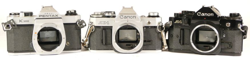 A Pentax Asahi K1000 camera (working) together with a Canon AE-1 camera (working) and a Canon A-1