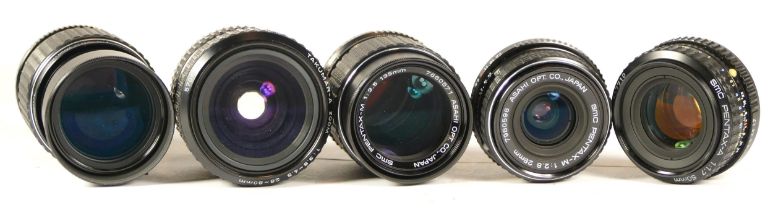 Five assorted camera lenses comprisingl SMC Pentax-M Zoom 1:4 75-150mm, SMC Pentax-M1:2.8 28mm,