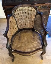 An Edwardian Mahogany and cane bergère chair, standing on out swept cabriole legs, H88, W64cm