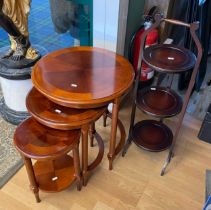 A nest of three contemporary circular occasional tables, raised on turned supports together with