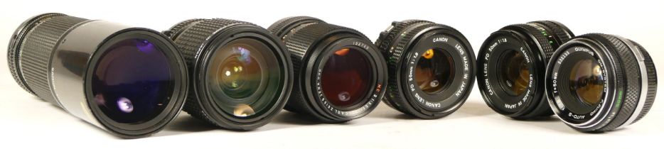Six assorted camera lens to include Canon and Olympus (mechanically working requires strip clean)