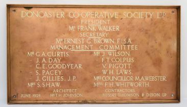 A cast brass wall plaque 'Doncaster Co-Operative Society Ltd' , circa 1928, 76x43cm.