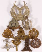 Ten military cap badges, including Royal Armoured Corps and RAF
