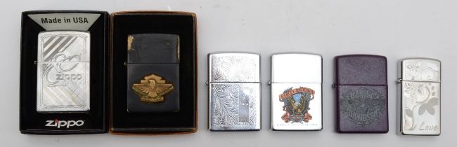 A collection of six Zippo cigarette lighters, pocket petrol filled examples.