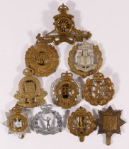 Ten military cap badges, including Dorsetshire and RAF